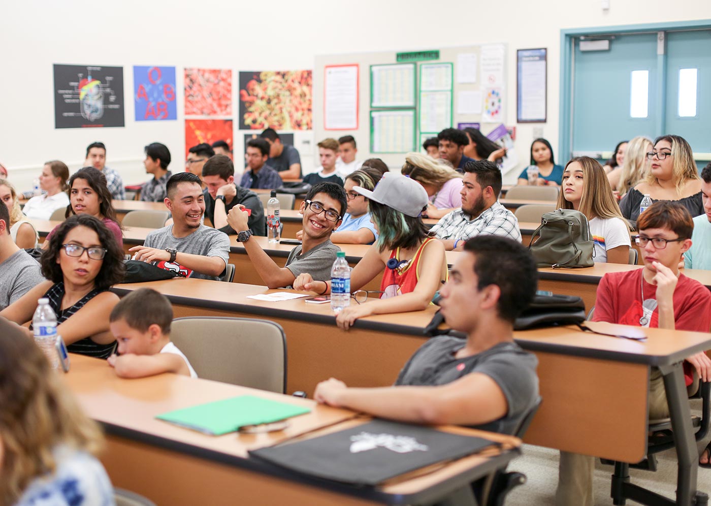 Students sitting and talking in a classroom.